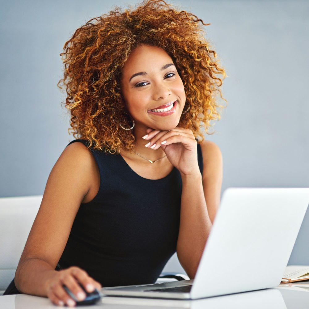 portrait-of-a-young-businesswoman-working-on-a-laptop-at-her-desk.jpg