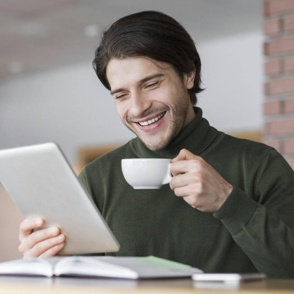 young-successful-businessman-checking-emails-while-having-morning-coffee-1.jpg